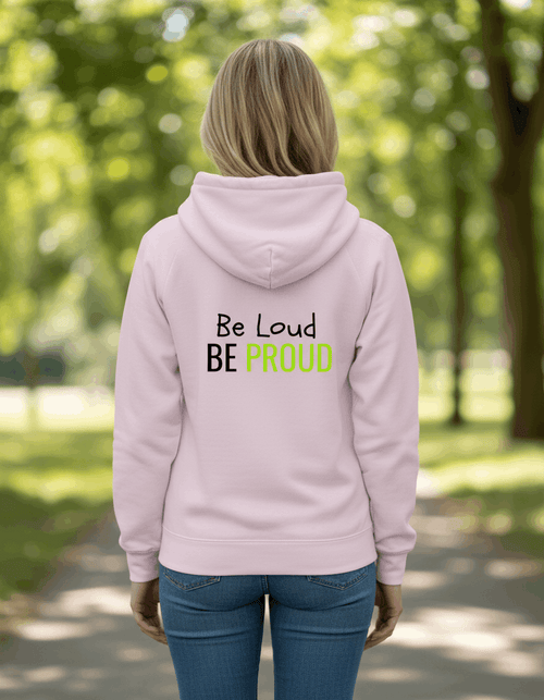 Light pink ultra-soft sensory-friendly hoodie with 'Be Loud BE PROUD' text in black and neon green, designed for neurodivergent self-expression.